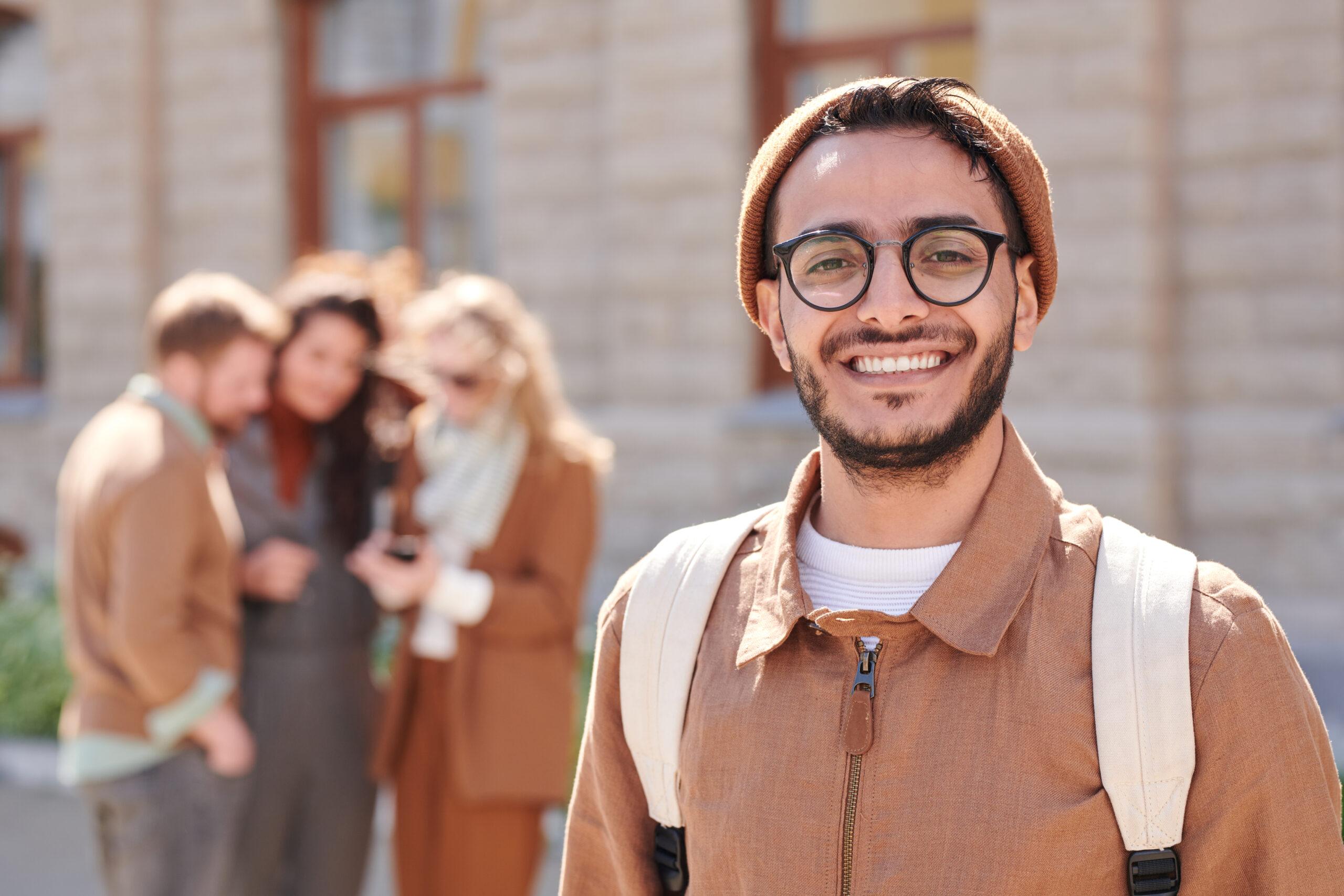 Cheerful Arabian man in eyeglasses outdoors