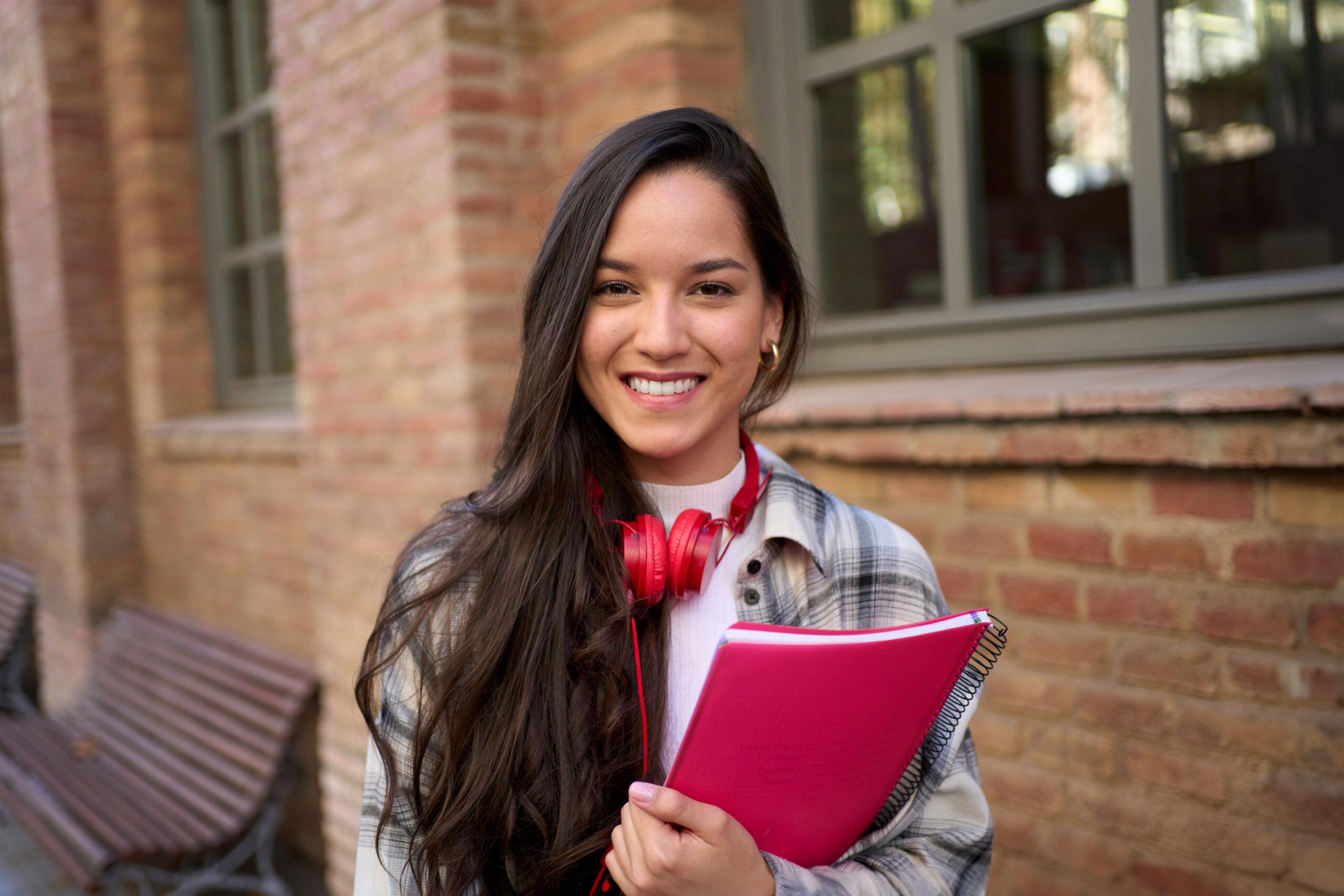 Portrait of happy young European woman happy smiling face on street. Female people cheerful